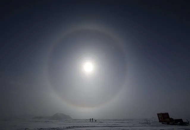 A picture made available 29 December 2015 shows Scientists measuring the solar radiation, at the Glaciar Union camp in the Antarctica, 18 November 2015. The ozone hole has reached a record size with 10 squared kilometers in December 2015, more than the double of the average of the season, according to data published on 28 December 2015 by the University of Santiago de Chile (Usach). (Photo by Felipe Trueba/EPA)