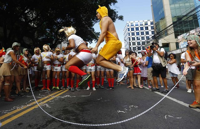 Revellers attend the annual block party known as the “Suvaco do Cristo” (Armpit of Christ), one of the many pre-carnival parties to take place in the neighbourhoods of Rio de Janeiro, February 8, 2015. (Photo by Ricardo Moraes/Reuters)