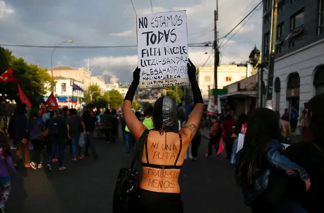 A participant holds a placard, which reads: “We are not complete, missing: Nicole, Litzi, Sandra” during a rally against gender violence on the International Day for the Elimination of Violence Against Women, in Valparaiso, Chile, November 25, 2016. (Photo by Rodrigo Garrido/Reuters)