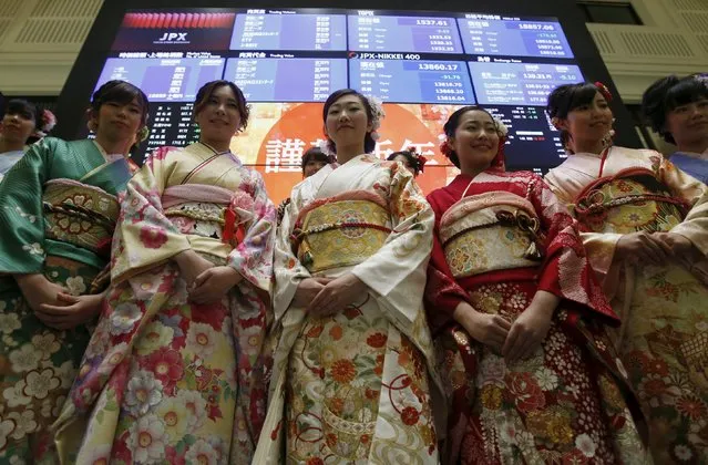 Women, dressed in ceremonial kimonos, pose for the pictures in front of an electronic board showing the Japan's Nikkei average after the New Year opening ceremony at the Tokyo Stock Exchange (TSE), held to wish for the success of Japan's stock market, in Tokyo, Japan, January 4, 2016. Japan's Nikkei fell 1 percent, playing catch-up to falls in U.S. stocks in the last two sessions during Japan's market holidays. The Nikkei gained around 9 percent last year. (Photo by Yuya Shino/Reuters)
