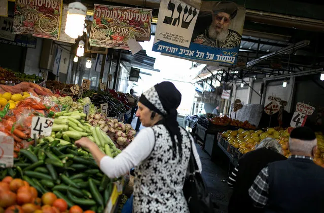 A religious Jewish woman shops for vegetables at a market in Tel Aviv, Israel March 10, 2015. (Photo by Baz Ratner/Reuters)