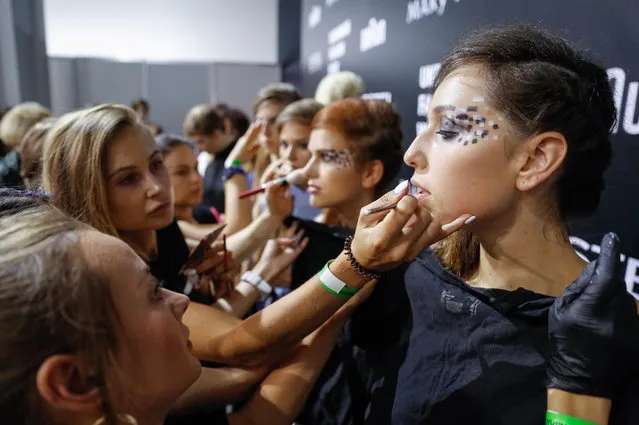 Models get their makeup backstage during the Ukrainian Fashion Week in Kiev, Ukraine, 01 September 2018. (Photo by Sergey Dolzhenko/EPA/EFE)