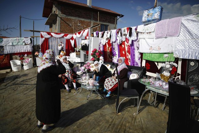 Bulgarian Muslim women chat in front of a dowry during the wedding ceremony of Bulgarian Muslims Fikrie Bindzheva and Azim Liumankov in the village of Ribnovo, in the Rhodope Mountains, February 15, 2015. (Photo by Stoyan Nenov/Reuters)