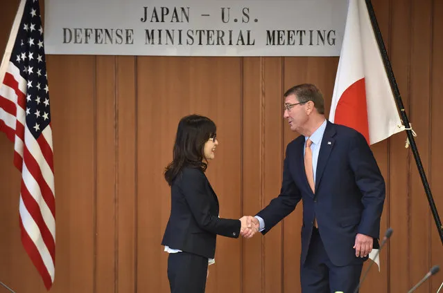 U.S. Defense Secretary Ash Carter and Japan's Defense Minister Tomomi Inada (L) shake hands before their meeting at the Defense Ministry in Tokyo, Japan, December 7, 2016. (Photo by Kazuhiro Nogi/Reuters)