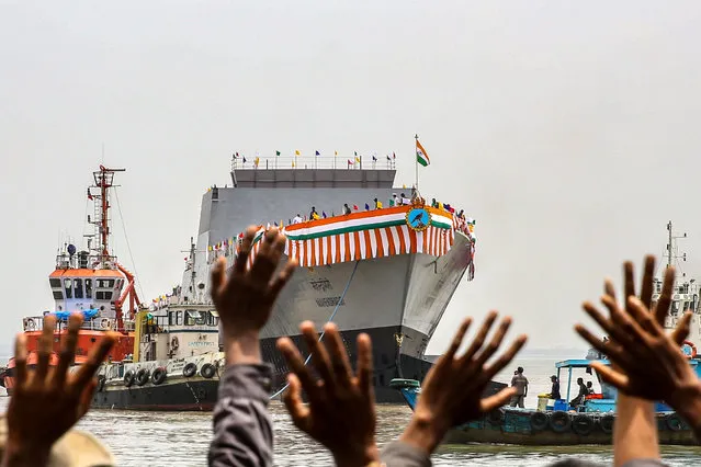 Indian workers from the Mazagon Dock wave towards the warship Mahendragiri, the seventh Stealth Frigate of Indian Navy's Project 17 A, built by Mazagon Dock Shipbuilders Limited (MDL), during its launch event in Mumbai, India on September 1, 2023. India's new warship Mahendragiri is the last Project 17A Frigate with improved stealth features, advanced weapons and sensors, and platform management system. (Photo by Divyakant Solanki/EPA/EFE)