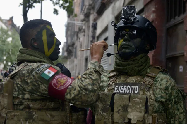 Members of the Mexican armed forces get ready to participate in the military parade for the 213th anniversary of Independence Day at the Zocalo Square in Mexico City on September 16, 2023. (Photo by Lucia Flores/AFP Photo)