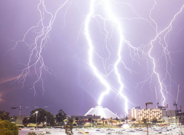 Lightning strikes the Crown Entertainment Complex on January 29, 2015 in Perth, Australia. The dramatic scenes were captured by photographer Peter Coe using his Canon 600D. The strike knocked out power to the immediate surrounding area, setting car alarms off. (Photo by Peter Coe/Barcroft USA)