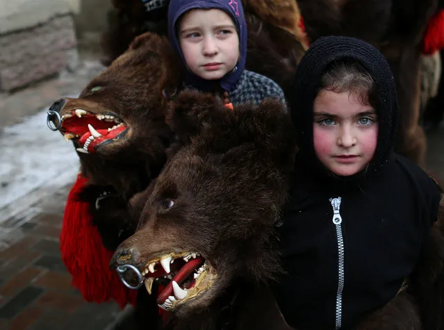 Children wearing costumes made of bearskins take part in a festival in the town of Comanesti, Romania December 30, 2016. (Photo by Stoyan Nenov/Reuters)