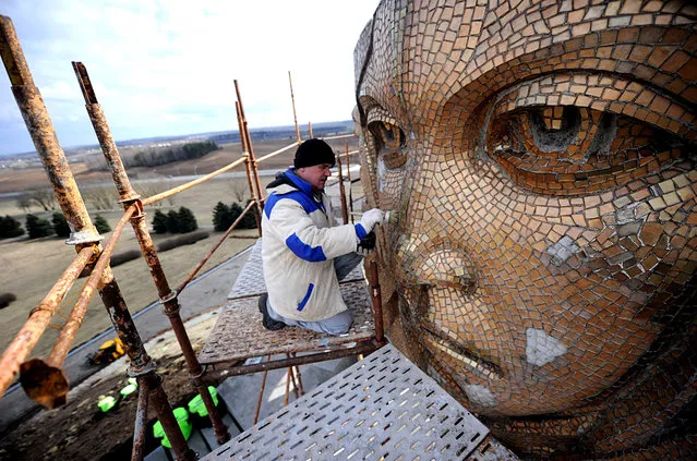 A worker renovates the Mound of Glory memorial complex honoring Soviet soldiers who fought during World War II in the village of Sloboda, some 25 kilometers east of Minsk, on April 3, 2015. Belarus will mark the 70th anniversary of the end of WWII on May 9, 2015. (Photo by Sergei Gapon/AFP Photo)