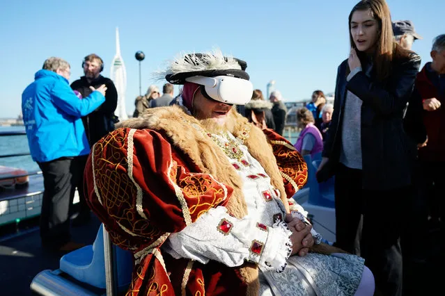 A Henry VIII interpreter on October 11, 2022 wears a VR headset to view a first person, underwater experience of the wreck of the Mary Rose, developed by the University of Portsmouth, as he joins other invited guests to travel by boat to lay 500 roses at the site of where the wreck of the Mary Rose was found, to mark the 40th anniversary of the raising of the ship in Portsmouth. (Photo by Andrew Matthews/PA Images via Getty Images)