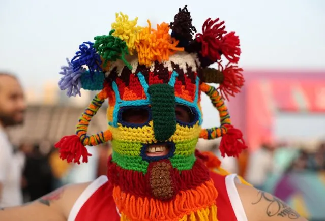 A fan wearing a face mask is pictured at the opening of the FIFA fan festival at Al Bidda Park, Doha, Qatar, November 19, 2022. (Photo by Molly Darlington/Reuters)