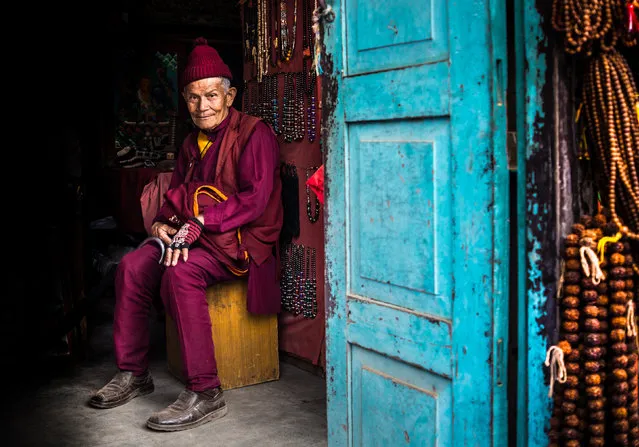 Bead man, Kathmandu, Nepal. Category: People. “While touring Bhaktapur, near Kathmandu, the brightly coloured door and hanging beads of this shop caught my attention. This sweet old man in national dress took great pride in his handmade beads”. (Photo by Francis Cox/National Geographic Traveller UK)