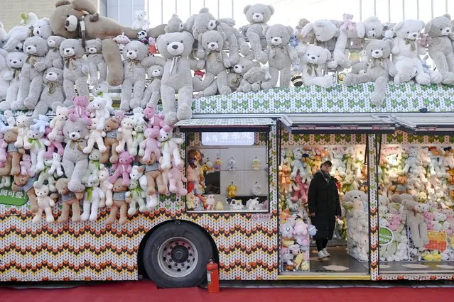 A woman is seen inside a toy shop converted from a trailer along a business street in Beijing on January 3, 2024. (Photo by Wang Zhao/AFP Photo)