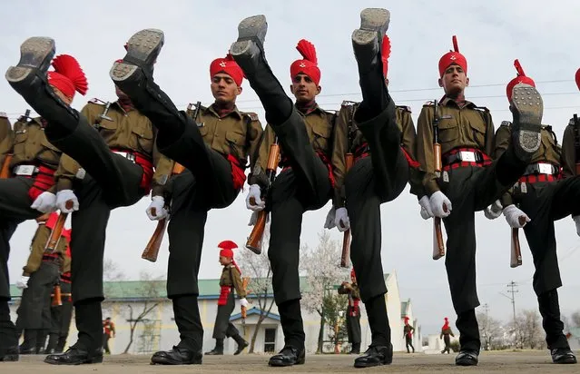 Indian army recruits wearing their ceremonial uniform perform a salute as they pose before their passing out parade at a garrison in Rangreth on the outskirts of Srinagar, March 5, 2016. A total of 242 youths from various religious backgrounds were formally inducted into the Indian army's Jammu and Kashmiri Light Infantry Regiment (JKLIR) after their 49-week training, an army official said. (Photo by Danish Ismail/Reuters)