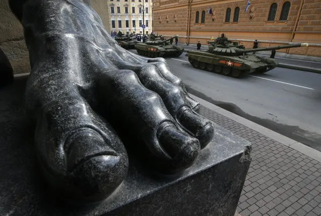 Russian T-72 tanks drive past a sculpture of Atlas at the State Hermitage museum during a rehearsal for the Victory Day military parade which will take place at Dvortsovaya (Palace) Square on May 9 to celebrate 70 years after the victory in WWII, in St. Petersburg, Russia, Thursday, April 30, 2015. (Photo by Dmitry Lovetsky/AP Photo)
