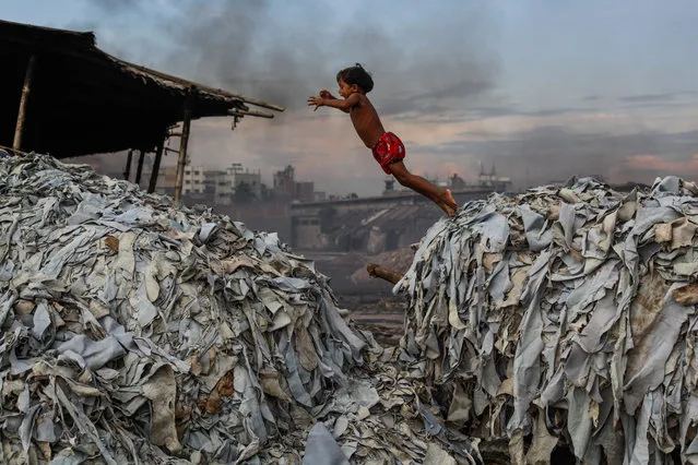 Fascinating faces and characters honourable mention – Child Plays in a Tannery. A child jumps on waste products used to make poultry feed, as she plays in a tannery in Hazaribagh, which is part of the old town in Dhaka, Bangladesh. (Photo by Andrew Biraj/SIPA Contest)