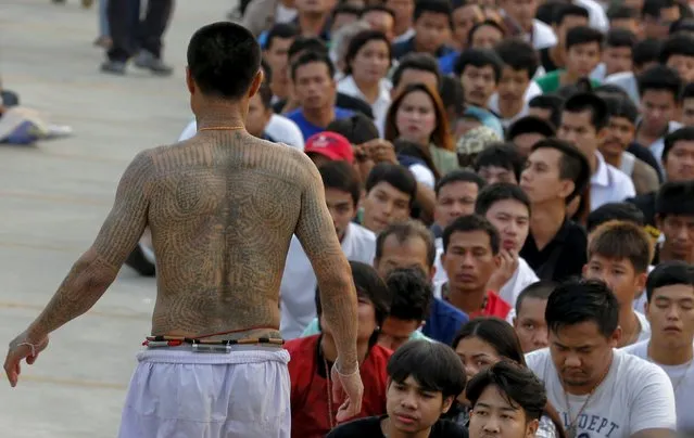 A devotee in a state of trance mimics creatures tattooed on his body during the annual Magic Tattoo Festival at Wat Bang Phra in Nakhon Pathom province, on the outskirts of Bangkok, Thailand, March 19, 2016. (Photo by Chaiwat Subprasom/Reuters)