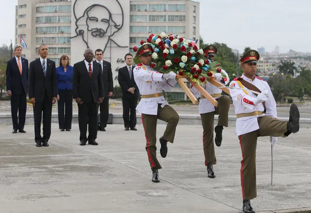 U.S. President Barack Obama, second from left, and Secretary of State John Kerry, left, stand as an honor guard marches during a ceremony to lay a wreath at the Jose Marti monument in Revolution Square in Havana, Cuba,  Monday March 21, 2016. Center left is Salvador Valdes Mesa Vice-President of Cuba's State Council. “It is a great honor to pay tribute to Jose Marti, who gave his life for independence of his homeland. His passion for liberty, freedom, and self-determination lives on in the Cuban people today”. (Photo by Enric Marti/AP Photo)