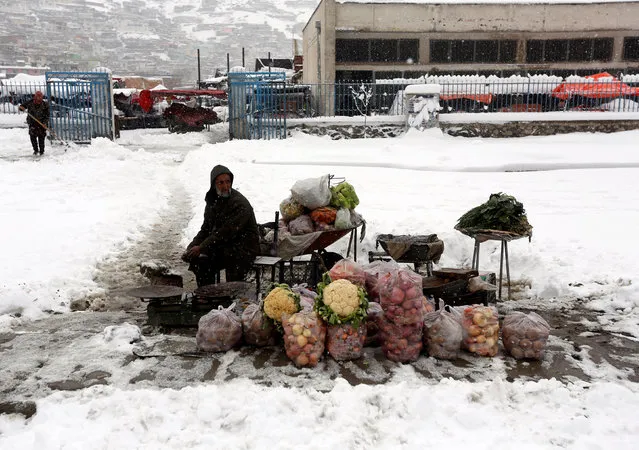 An Afghan man sells vegetables as he waits for customers on a snowy day in Kabul, Afghanistan February 5, 2017. (Photo by Omar Sobhani/Reuters)