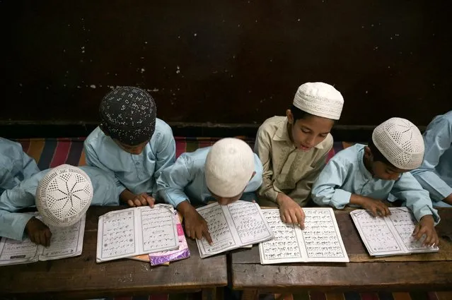 Students recite the Holy Quran in a classroom during the Islamic holy month of Ramadan at the Madrasatur-Rashaad religious school in Hyderabad, India on March 13, 2024. (Photo by Noah Seelam/AFP Photo)