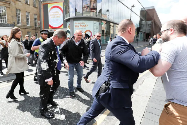 Brexit Party leader Nigel gestures after being hit with a milkshake while arriving for a Brexit Party campaign event in Newcastle, Britain, May 20, 2019. (Photo by Scott Heppell/Reuters)