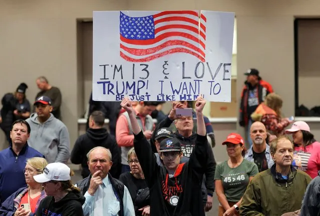 A supporter of Republican presidential candidate and former U.S. President Donald Trump holds a sign during a campaign rally in Green Bay, Wisconsin on April 2, 2024. (Photo by Brian Snyder/Reuters)