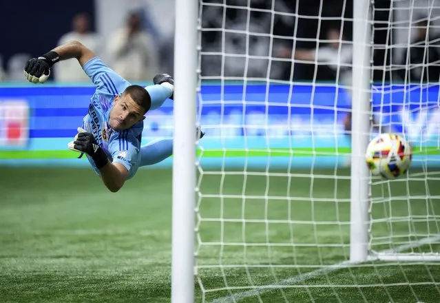 LA Galaxy goalkeeper John McCarthy allows a goal to Vancouver Whitecaps' Brian White during the second half of an MLS soccer match Saturday, April 13, 2024, in Vancouver, British Columbia. (Photo by Darryl Dyck/The Canadian Press via AP Photo)
