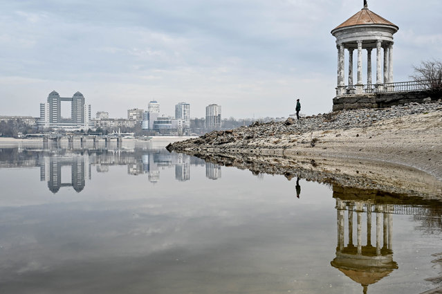 A person stays by a gazebo on Khortytsia Island against the skyline of the city in winter, Zaporizhzhia, southeastern Ukraine on February 14, 2024. (Photo by Ukrinform/Rex Features/Shutterstock)