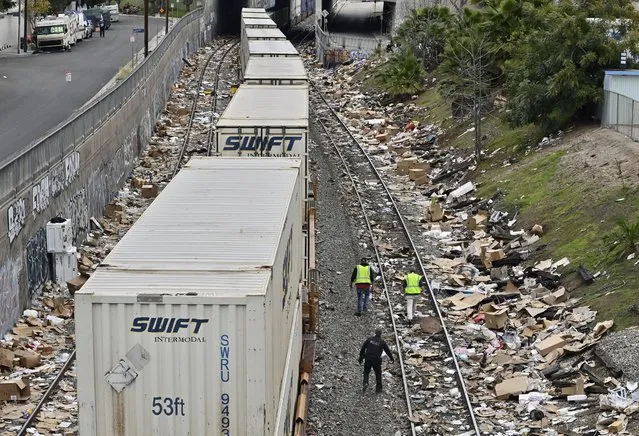 A Union Pacific freight train lies idle after derailing near an area where thousands of empty boxes were left by cargo thieves in the Lincoln Heights section of Los Angeles on Saturday, January 15, 2022. Dozens of freight cars are broken into every day on Los Angeles railways by thieves who take advantage of the train's stops to loot packages bought online leaving thousands of gutted boxes, including Amazon packages, UPS boxes, unused COVID tests, fishing lures and epi pens that will never reach their location. UPS bags are popular among “thieves opening cargo containers” because “they are often full of boxes with merchandise bound for residential addresses”, local law enforcement said. (Photo by Jim Ruymen/UPI/Rex Features/Shutterstock)
