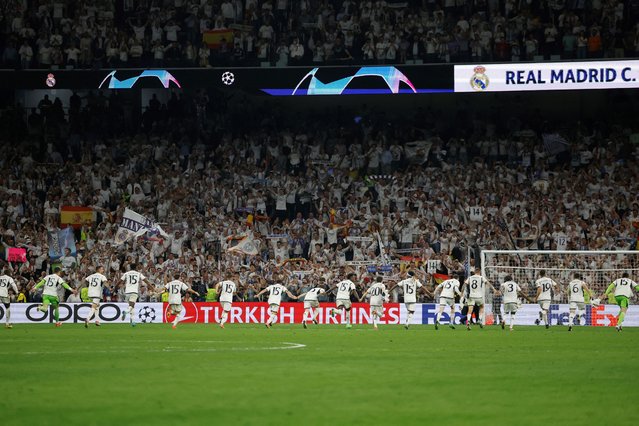Real Madrid's players celebrate victory at the end of the UEFA Champions League semi final second leg football match between Real Madrid CF and FC Bayern Munich at the Santiago Bernabeu stadium in Madrid on May 8, 2024. (Photo by Óscar del Pozo/AFP Photo)