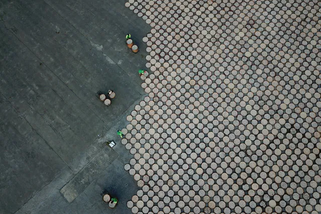 Workers arrange crackers for a drying proccess in Indramayu, West Java provinnce, Indonesia, June 17, 2019 in this photo taken by Antara Foto. (Photo by Dedhez Anggara/Antara Foto via Reuters)