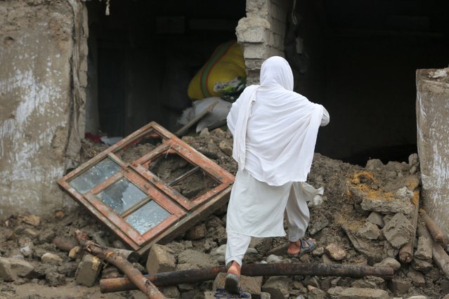 People salvage their belongings after heavy rains in Momand-Dara district of Nangarhar province, Afghanistan, 15 April 2024. According to the Afghanistan disaster management department, at least 33 people have been killed over three days of heavy rains and flash flooding. Authorities warned that Afghanistan's provinces will see more rain over the next few days. (Photo by EPA/EFE/Stringer)