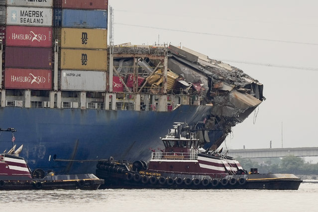 Tugboats escort the cargo ship Dali after it was refloated in Baltimore, Monday, May 20, 2024. The vessel on March 26 struck the Francis Scott Key Bridge causing it to collapse and resulting in the death of six people. (Photo by Matt Rourke/AP Photo)