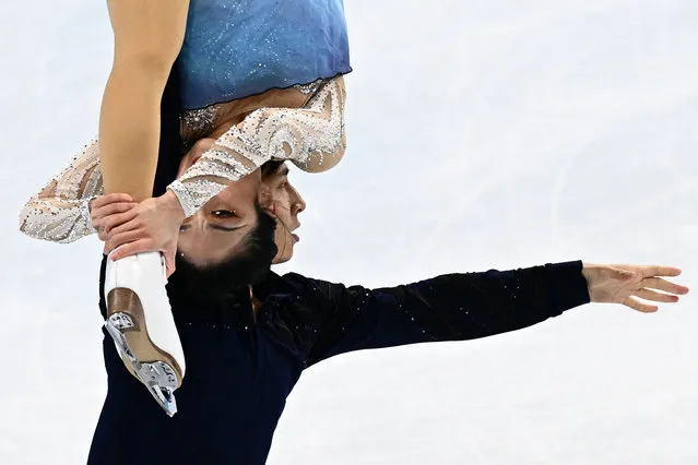 China's Sui Wenjing and China's Han Cong compete in the pair skating free skating of the figure skating event during the Beijing 2022 Winter Olympic Games at the Capital Indoor Stadium in Beijing on February 19, 2022. (Photo by Anne-Christine Poujoulat/AFP Photo)