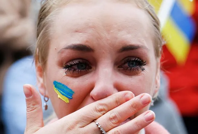 A Ukrainian woman living in Turkey weeps during a protest against Russia's military operation in Ukraine, in Ankara, Turkey on February 26, 2022. (Photo by Cagla Gurdogan/Reuters)