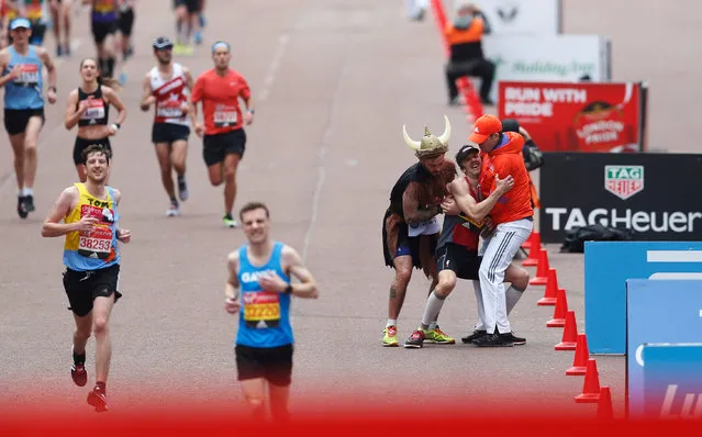 A London Marathon runner collapses just before reaching the finish line in London, England on April 23, 2017. (Photo by Matthew Childs/Reuters)