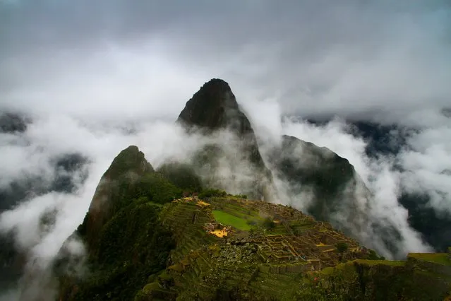 “The Lost City in the Clouds”. Even though the weather was not so good for my visit here, the clouds were swirling through the mountains quick enough to take this mystical shot of Machu Picchu. Photo location: Machu Picchu, Peru. (Photo and caption by Ben Caldwell/National Geographic Photo Contest)