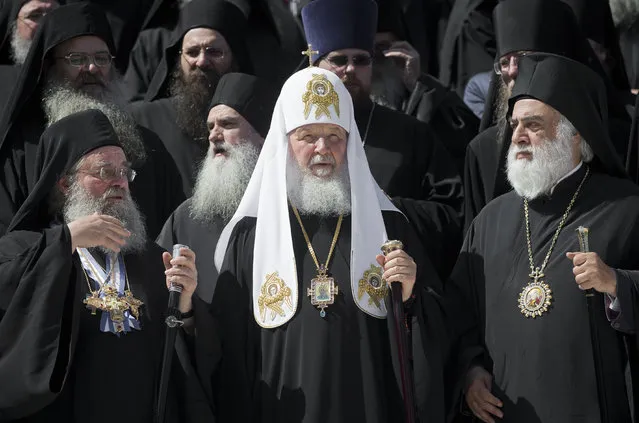 Patriarch Kirill of Moscow, center, poses for cameras with orthodox monks in Karyes, the capital of Mount Athos, Greece, Friday, May 27, 2016, ahead of Russia's president Putin visit. (Photo by Darko Bandic/AP Photo)