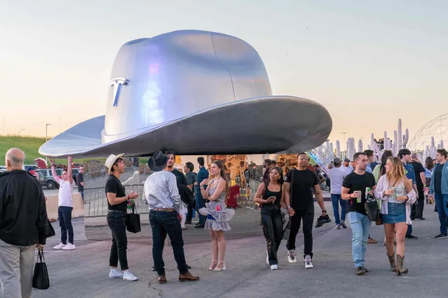 A giant cowboy hat is on display outside the Tesla Giga Texas manufacturing facility during the “Cyber Rodeo” grand opening party on April 7, 2022 in Austin, Texas. Tesla welcomed throngs of electric car lovers to Texas on April 7 for a huge party inaugurating a “gigafactory” the size of 100 professional soccer fields. (Photo by Suzanne Cordeiro/AFP Photo)