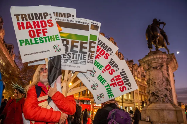 Crowds of people marched from Trafalgar Square to Buckingham Palace in protest of military activity of US President Donald Trump with support of NATO during an official diner at Buckingham Palace on the first day of the 70th NATO summit in London, England on December 3, 2019. Such issues as Turkish war on Kurds, displacement of indigenous people in Bolivia, occupation in Palestine and domestic problem of privatisation of NHS were risen during the protest. (Photo by Guy Bell/Rex Features/Shutterstock)