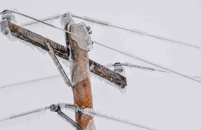 In this image provided by Verendrye Electric Cooperative, an ice-covered power line is seen in North Dakota on April 25, 2022. Ugly weather in North Dakota has left at least 19,000 people in the western part of the state facing days without power. It also left thousands residents along the Red River that separates the state from Minnesota dealing with flash flooding. (Photo by Verendrye Electric Cooperative via AP Photo)