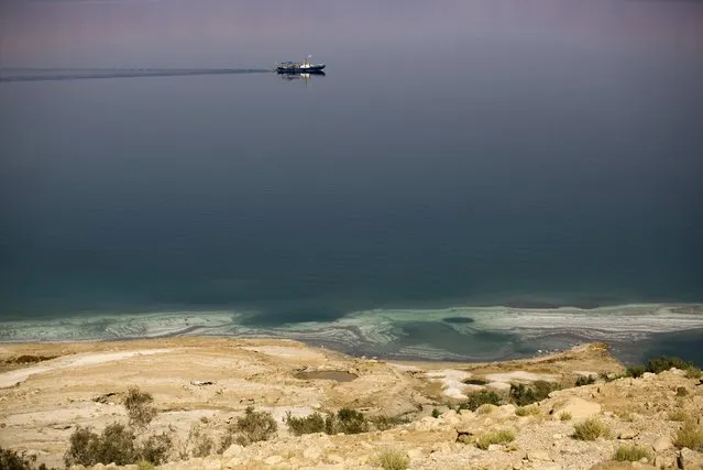 A sinkhole is seen on the shore of the Dead Sea near Kibbutz Ein Gedi, Israel July 27, 2015. (Photo by Amir Cohen/Reuters)