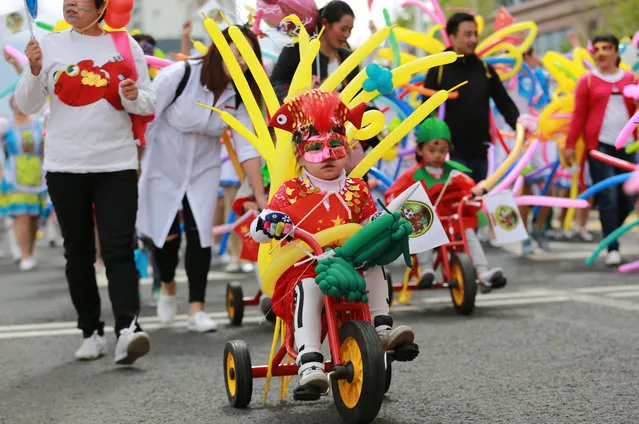 Students with parents and teachers from 14 Chinese schools and 2 Russian schools parade during a carnival to welcome the upcoming International Children's Day on May 31, 2017 in Heihe, Heilongjiang Province of China. 14 Chinese schools and 2 Russian schools held a dress-up carnival on Wednesday in Heihe to welcome the International Children's Day. (Photo by VCG/VCG via Getty Images)