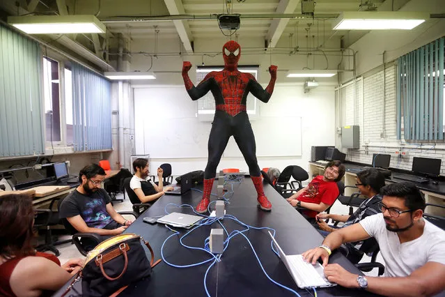 Moises Vazquez, 26, known as Spider-Moy, a computer science teaching assistant at the Faculty of Science of the National Autonomous University of Mexico (UNAM), who teaches dressed as a comic superhero Spider-Man, poses for a photograph during a class in Mexico City, Mexico, May 27, 2016. (Photo by Edgard Garrido/Reuters)