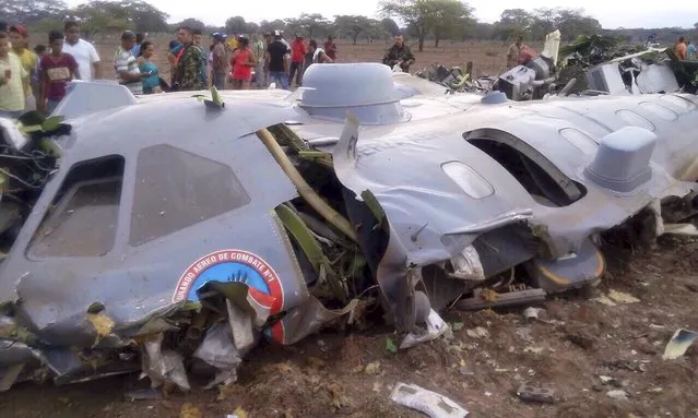 Debris of a crashed transport plane of Colombian Air Force is seen near the town of Codazzi, about 600 kilometers (372 miles) northeast of Bogota, Colombia, near the border with Venezuela July 31, 2015. Eleven Colombian military personnel were killed on Friday when their transport plane suffered motor failure and crashed in the northern province of Cesar, killing all on board, according to a statement from the Air Force. (Photo by Reuters/Colombian Air Force)