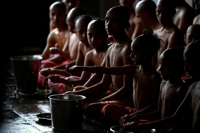 Novice Hindus undergo a ritualistic bath to mark the Janai Purnima festival (Sacred Thread Festival) during which devotees take holy baths and change their sacred thread, also known as Janai, for protection and purification, at the premises of the Pashupatinath Temple in Kathmandu, Nepal, on August 19, 2024. (Photo by Monika Malla/Reuters)