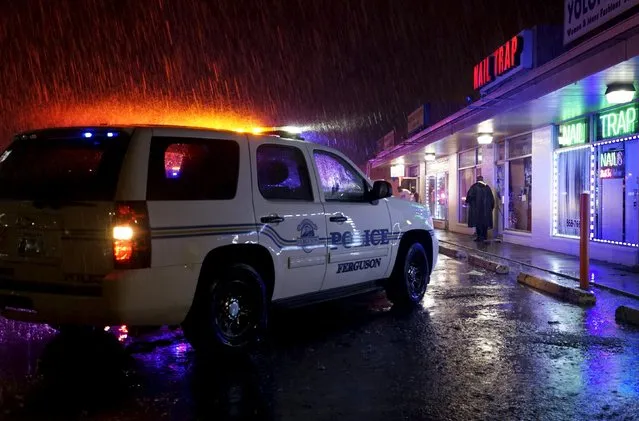 A Ferguson police unit is parked at outside the looted Bowen Beauty Supply at the site of last year's riots on the one year anniversary of the killing of Michael Brown in Ferguson, Missouri August 9, 2015. (Photo by Rick Wilking/Reuters)