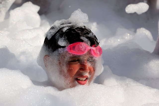 A child enjoys playing during a bubbles party amid a heatwave at a Red Sea resort in Hurghada, Egypt on July 30, 2024. (Photo by Mohamed Abd El Ghany/Reuters)