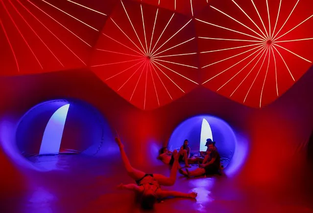 Revellers relax inside a 3-D Luminarium inflatable installation by British designer Alan Parkinson during Sziget music festival on an island in the Danube River in Budapest, Hungary August 12, 2015. (Photo by Laszlo Balogh/Reuters)