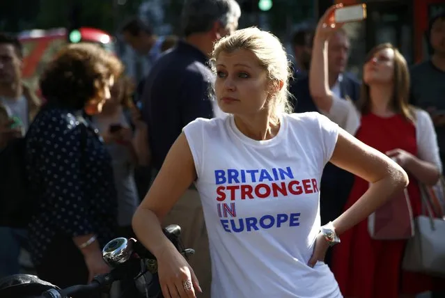 A woman wearing a vote remain tee-shirt reacts, following the result of the EU referendum, in London, Britain June 24, 2016. (Photo by Neil Hall/Reuters)